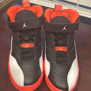 Jordan Black and Red Sneakers with High-Top Design and Iconic Strap